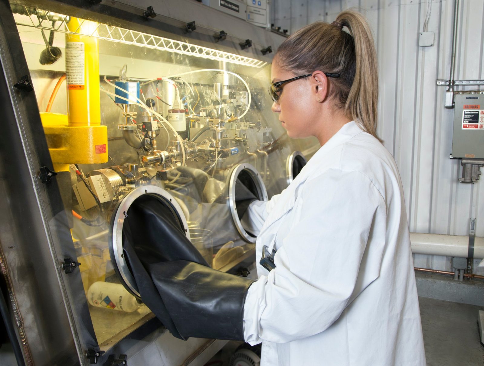 Technician working inside a glovebox