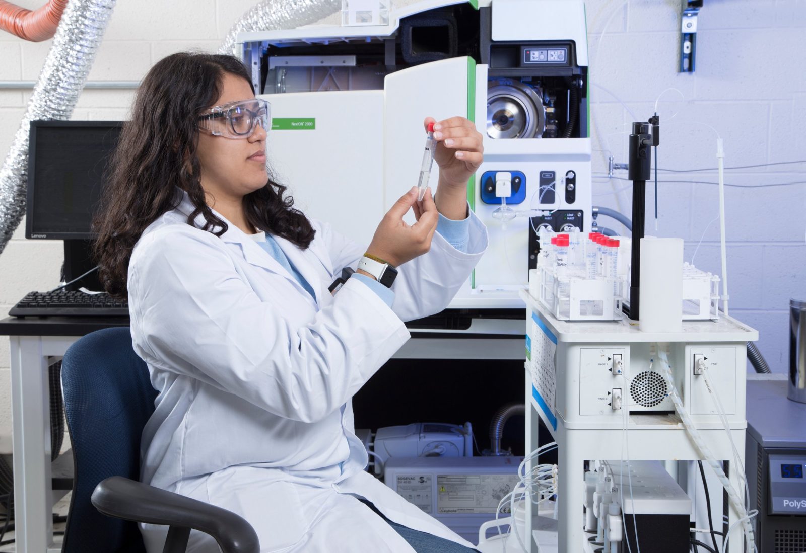 Laboratory analyst preparing a sample at an ICP-MS instrument