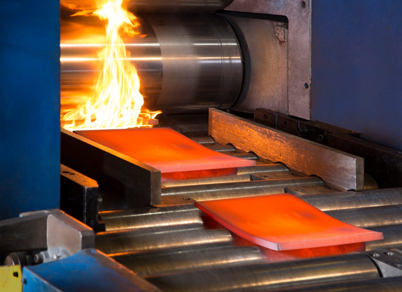 Glowing hot metal plate passing through a rolling mill