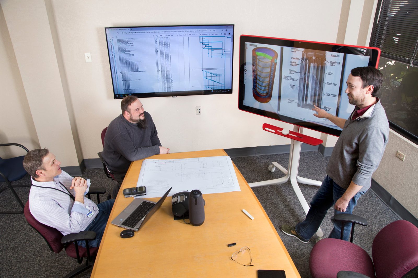 Engineers reviewing a design and project schedule